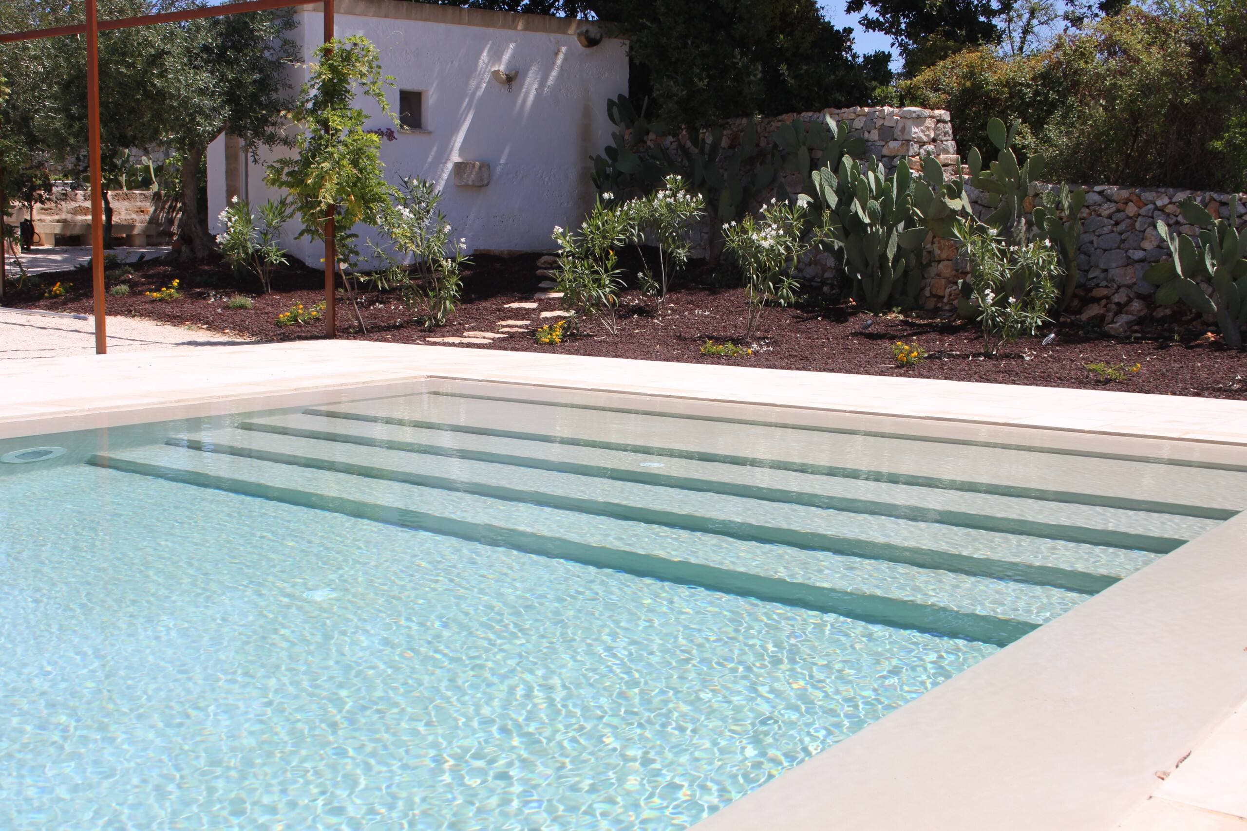 The pool's submerged steps, facing the cactus garden and the dry-stone wall